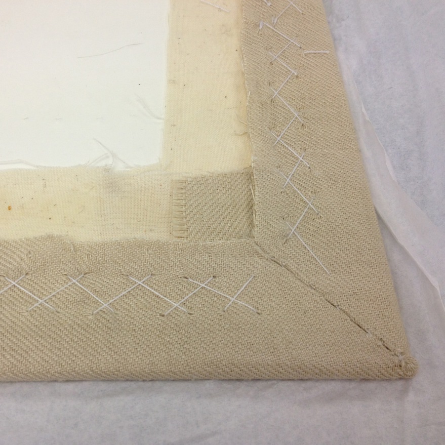 mount board with glued calico and herringbone stitched exbroidery piece